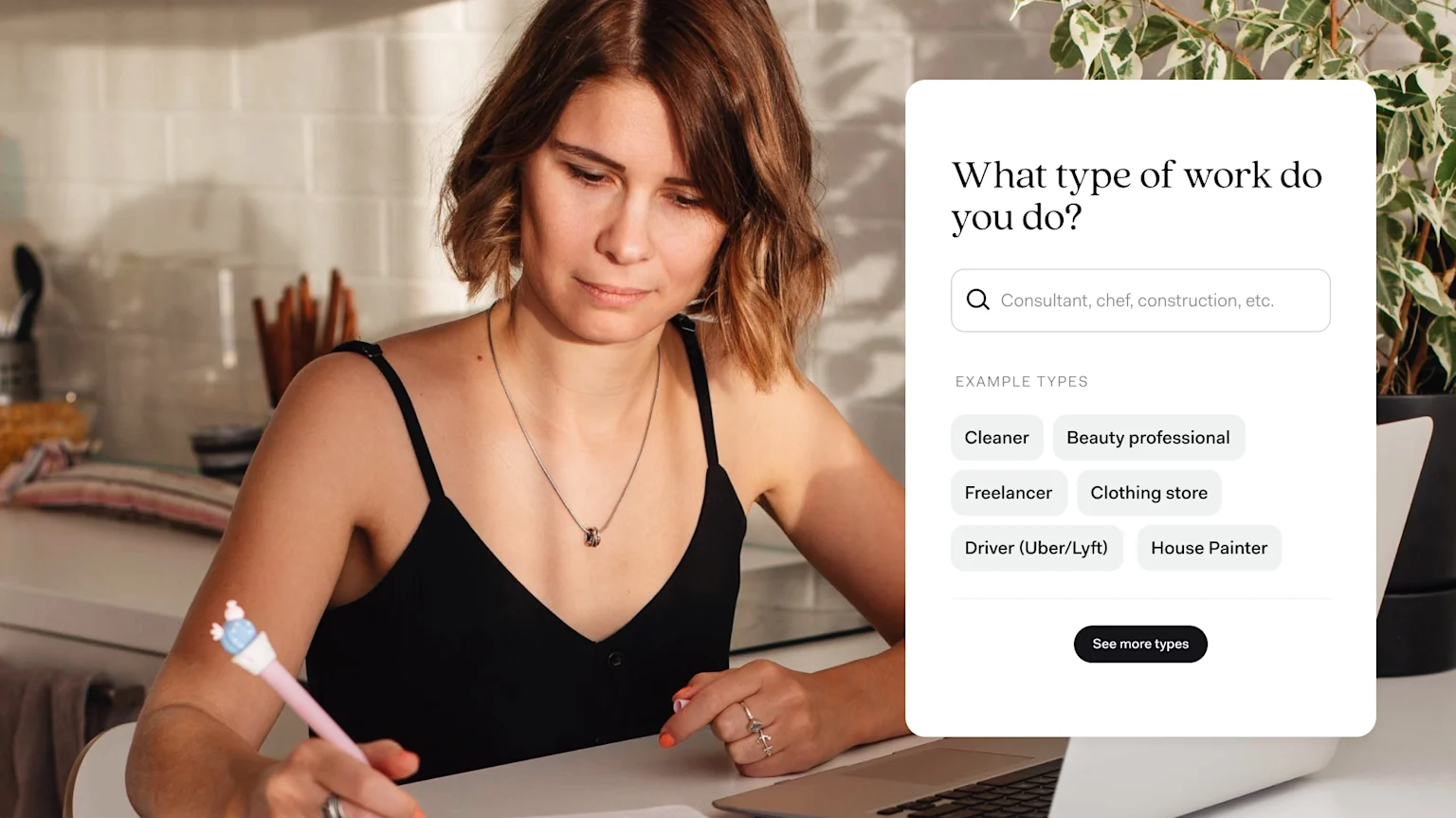 A woman writing at a desk beside a laptop, with an app screen asking 'What type of work do you do?' and example options like Cleaner, Freelancer, and Driver (Uber/Lyft)