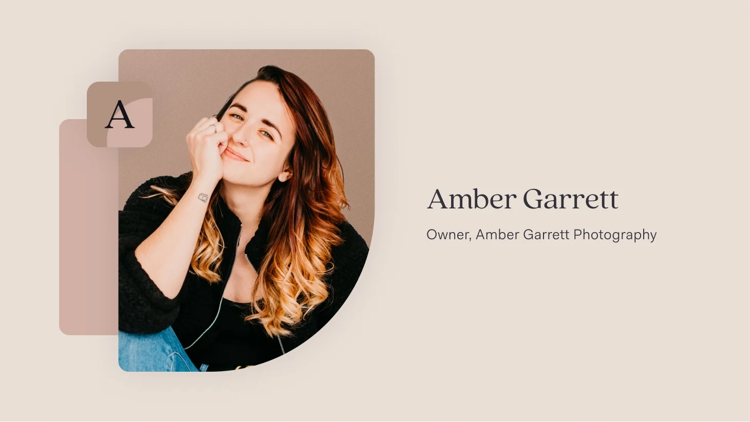 Amber Garrett, owner of Amber Garrett Photography, smiling with her hand resting near her chin