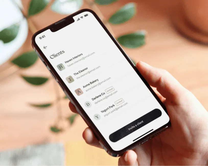 A phone showing a list of client businesses in the Found app, with a button to invite another client
